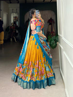 Load image into Gallery viewer, Complete Dola Silk ensemble featuring Kalamkari printed stitched lehenga with zari border, unstitched matching blouse, and coordinating tasseled dupatta. Lehenga includes drawstring closure and cotton inner lining.

