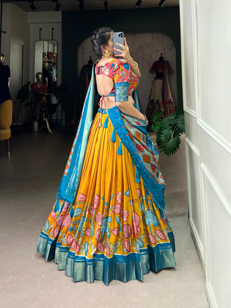 Complete Dola Silk ensemble featuring Kalamkari printed stitched lehenga with zari border, unstitched matching blouse, and coordinating tasseled dupatta. Lehenga includes drawstring closure and cotton inner lining.
