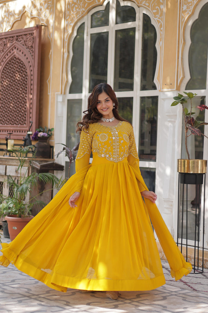 Yellow Gown with Dupatta , Elegant Yellow Embroidered Gown , Party Wear Yellow Gown , Yellow Full Sleeve Gown , Stylish Yellow Gown for Wedding , Yellow Cotton Lining Gown , Faux Blooming Yellow Gown
 , Yellow Floor Length Gown , Yellow Gown for Haldi Ceremony , Yellow Gown with Gathering Dupatta . 