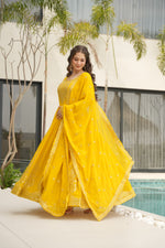 Load image into Gallery viewer, Yellow  gown with embroidered dupatta , Wedding wear yellow gown with ethnic design , Sunshine yellow sequin gown for special occasions , Yellow heavy work gown for celebrations , Mustard yellow faux blooming gown for women ..
