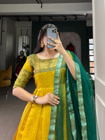 Load image into Gallery viewer, Yellow Color Kanjivaram Anarkali Zari Weaving Work With Price and Online Shopping Price Under 1500 .  Elegant Kanjivaram stitched gown with zari weaving, silk lining, and 3.5-meter flair. Paired with a plain net dupatta featuring a lace border. Perfect for festive occasions.
