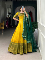 Load image into Gallery viewer, Yellow partywear gown with traditional vibes , Yellow gown for ethnic occasions and puja wear , Yellow zari woven gown with soft silk lining , Ethnic wear yellow gown with net dupatta set , Comfortable and elegant yellow color gown , Flowy yellow Kanjivaram gown with lace details . 
